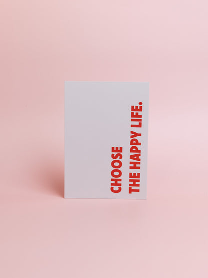 Postkarte mit dem Schriftzug "Choose the happy life" in Rot